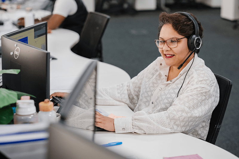 Female sat at desk with headset on