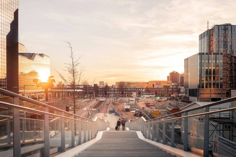 architectural structure photography of two people on stairs near buildings