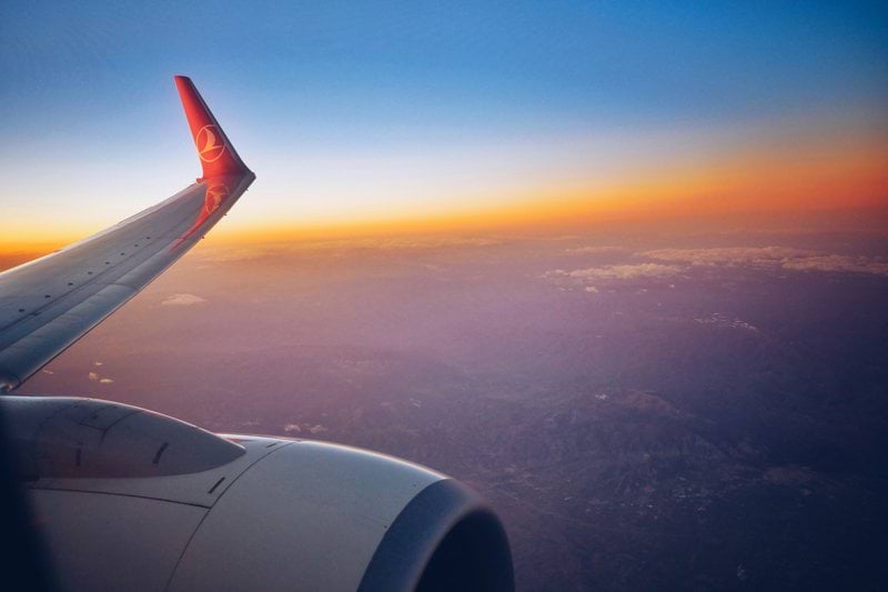 photograph white and red airplane wing