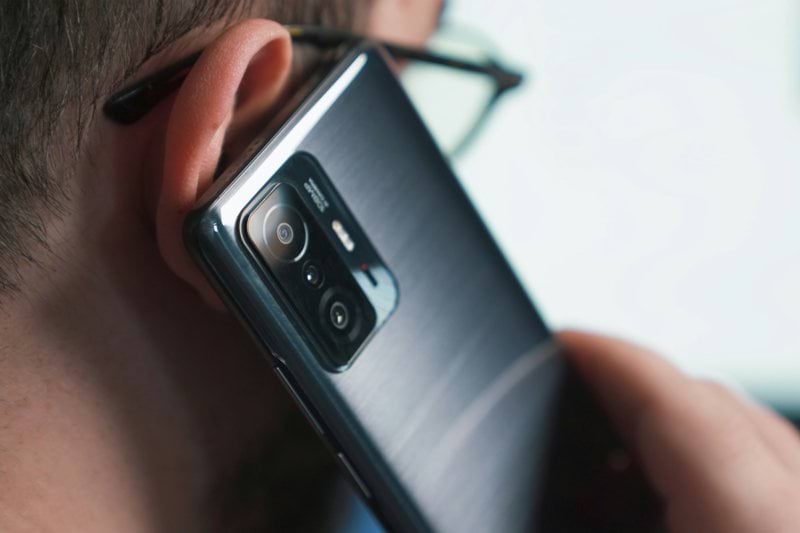 a close up of a person talking on a cell phone