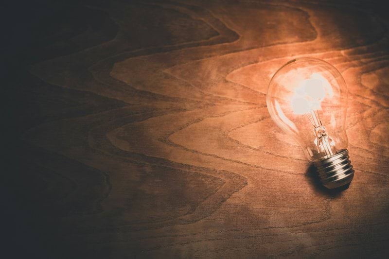 a light bulb sitting on top of a wooden table