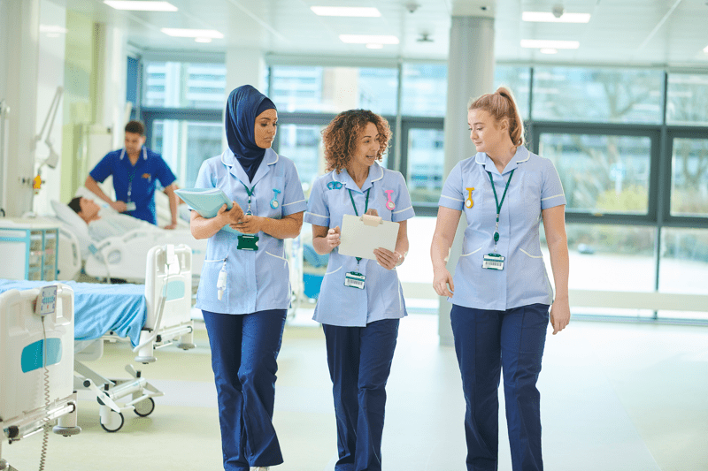 Three Female Nurses Walking in a Hospital
