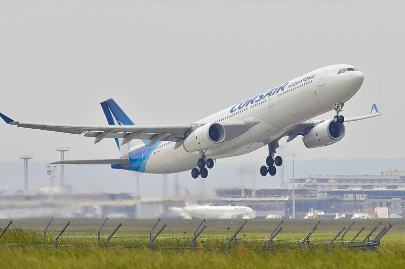 white and blue airplane about to fly at the airport