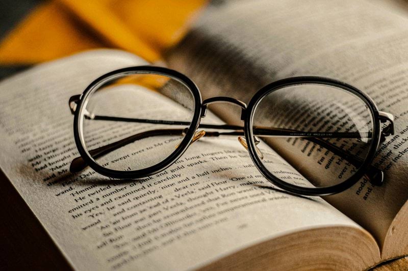 black framed eyeglasses on book page