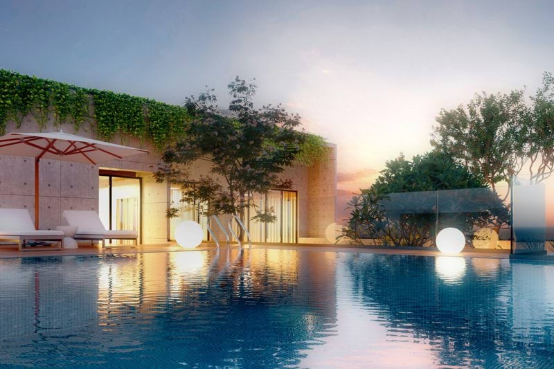 Luxury infinity pool at sunset with lounge chairs.