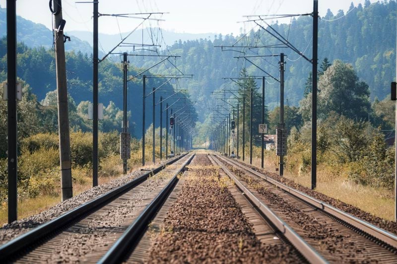 a train track running through a rural countryside