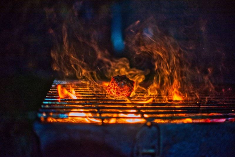 fire on black charcoal grill