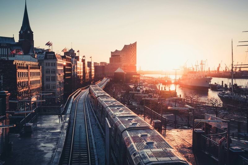 city buildings near the road during sunset