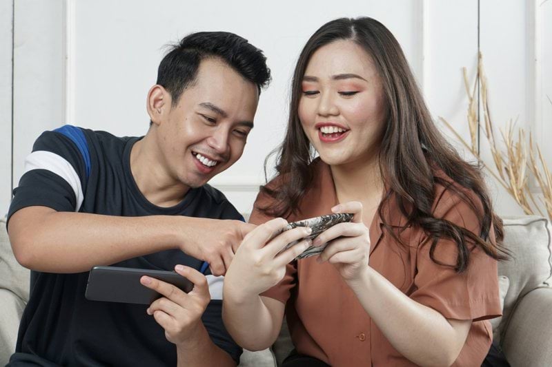 man and woman siting on sofa chair inside room