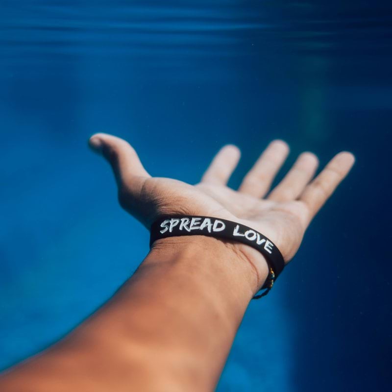 person wearing black silicone bracelet
