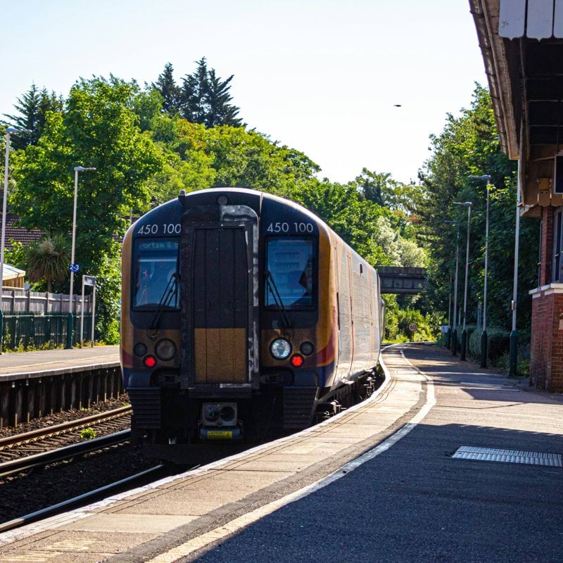 blue and white train on rail road during daytime