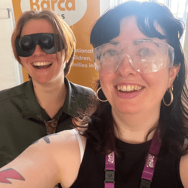 Two people taking a selfie while wearing large glasses