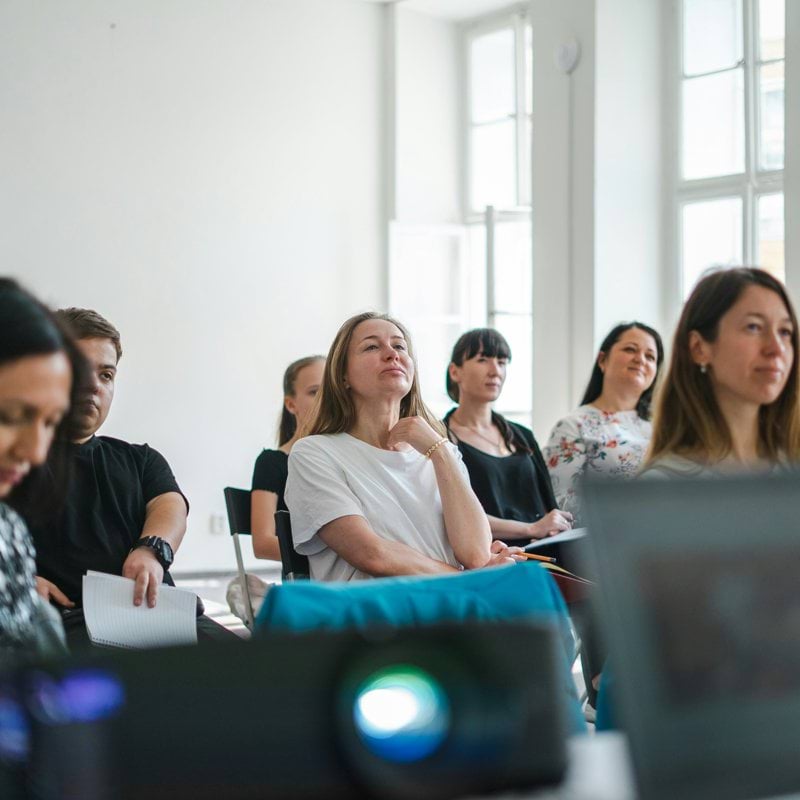 a group of people sitting at computers