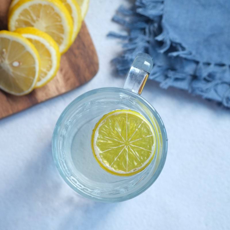 sliced lemon on clear glass saucer