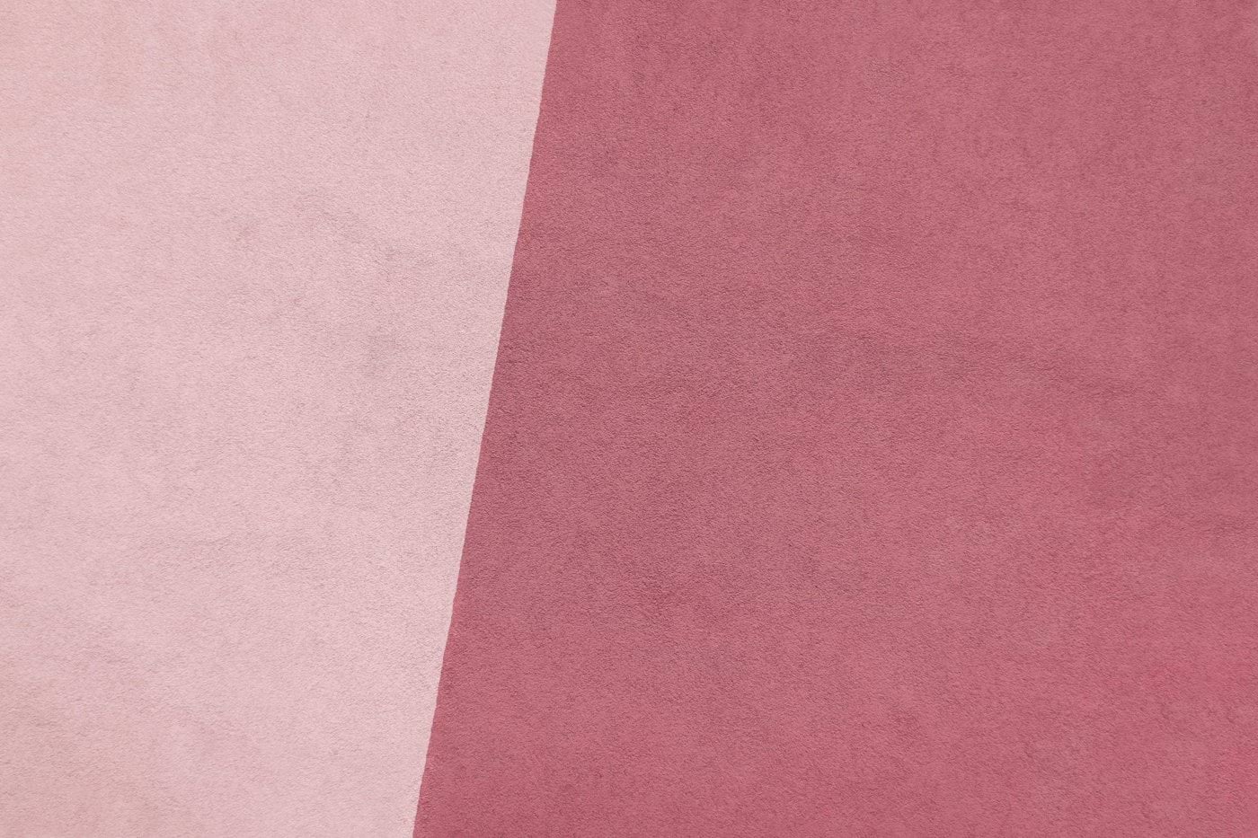 a close up of a pink and white background