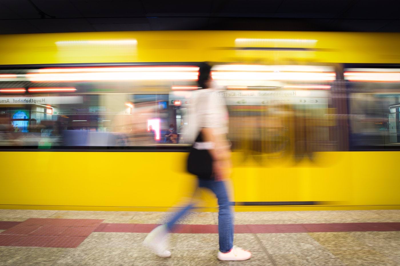 a blurry photo of a person walking in front of a train