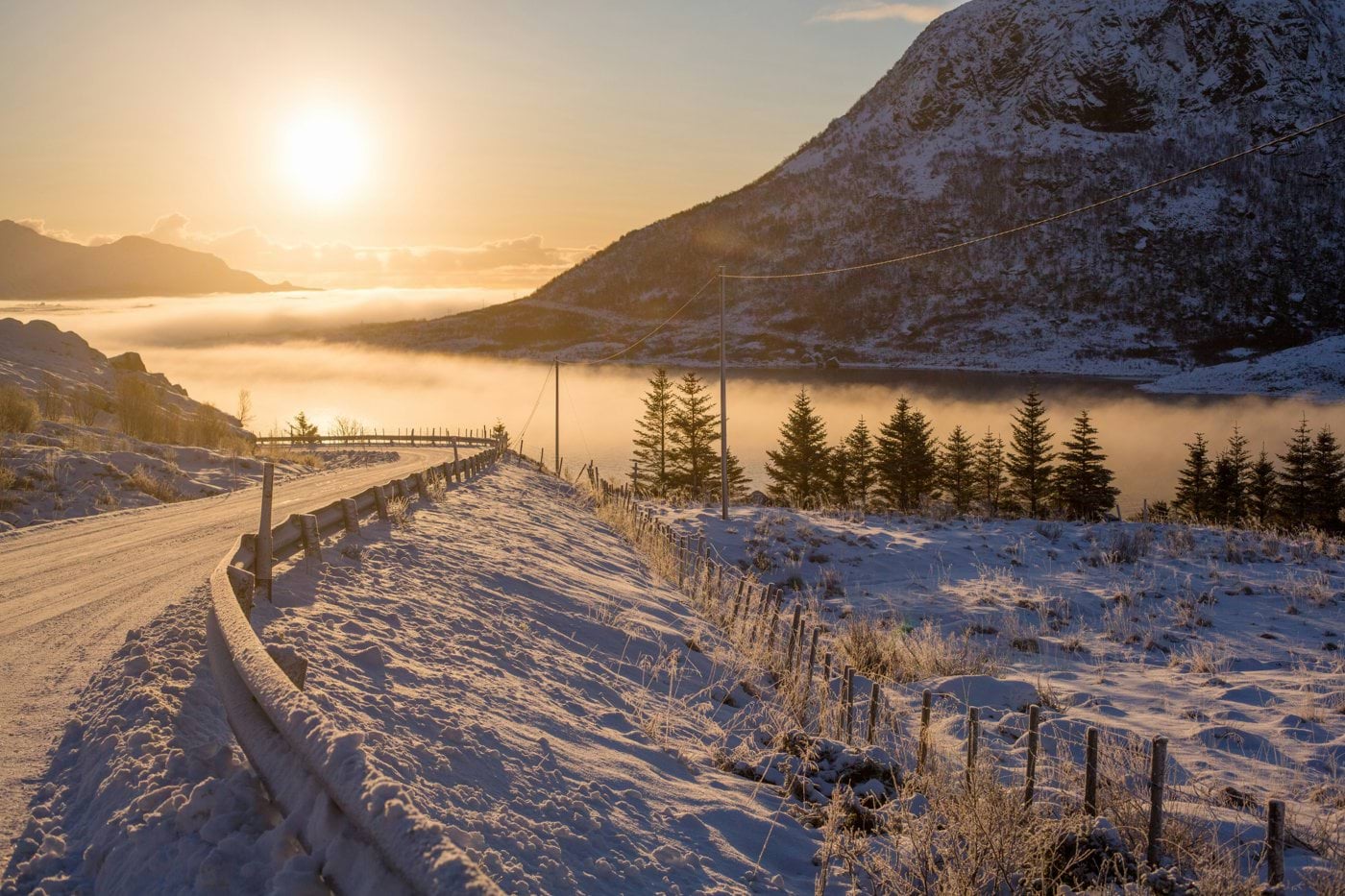 road near misty body of water