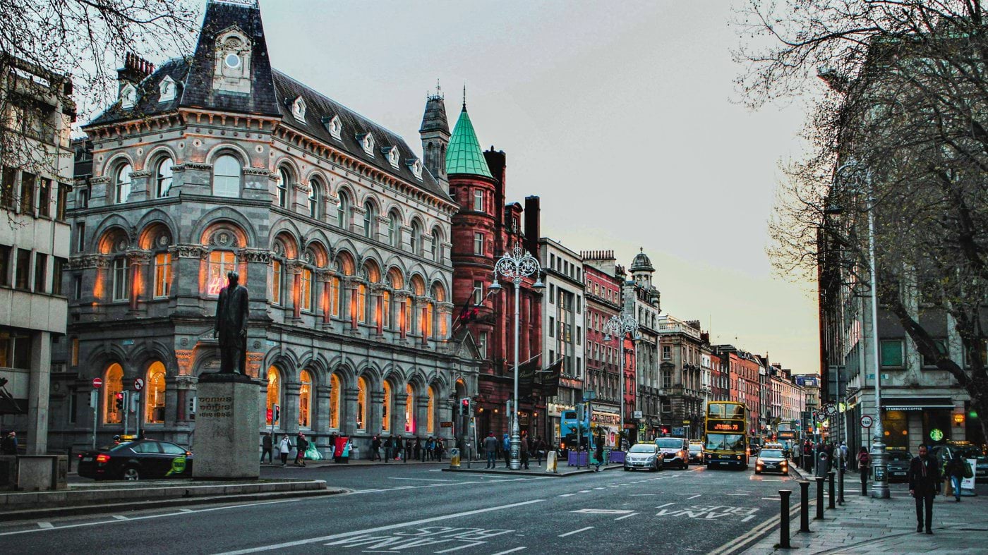 a city street with a clock tower in the middle of it