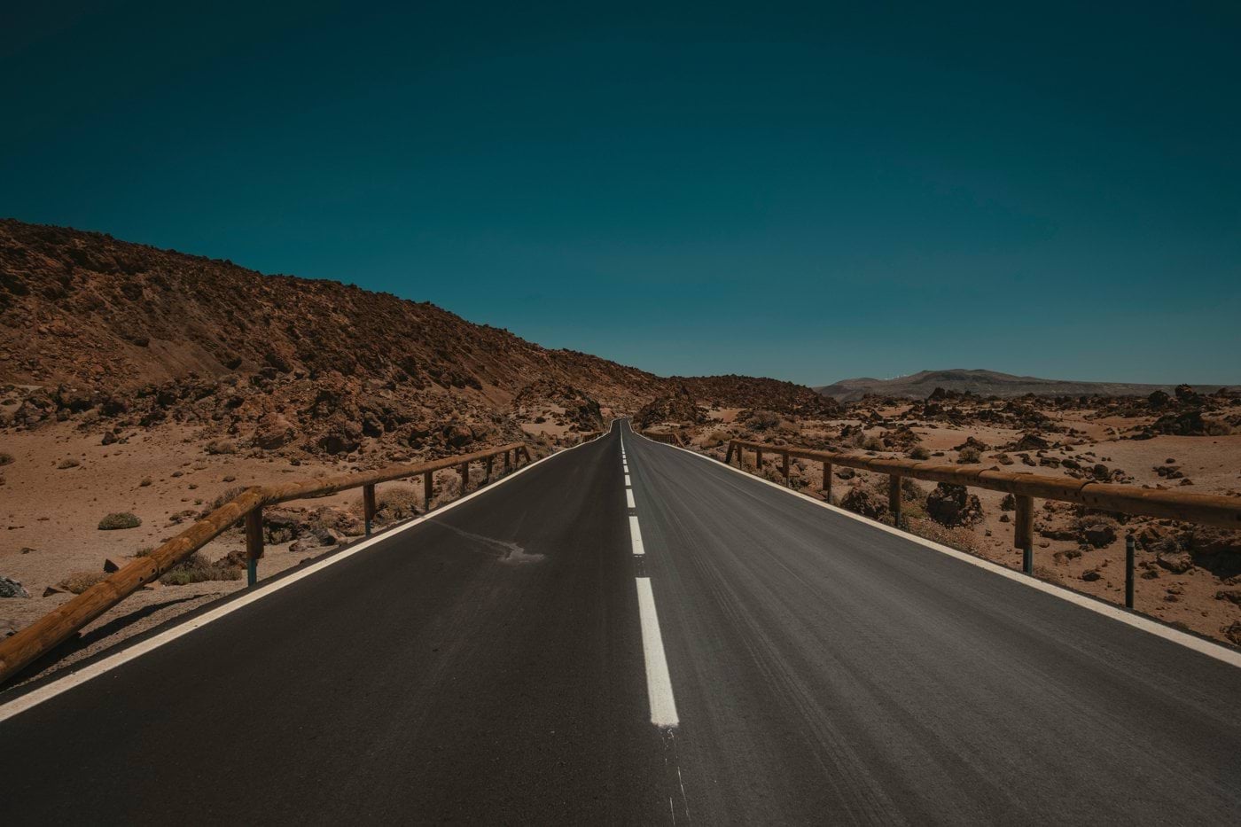 an empty road in the middle of a desert