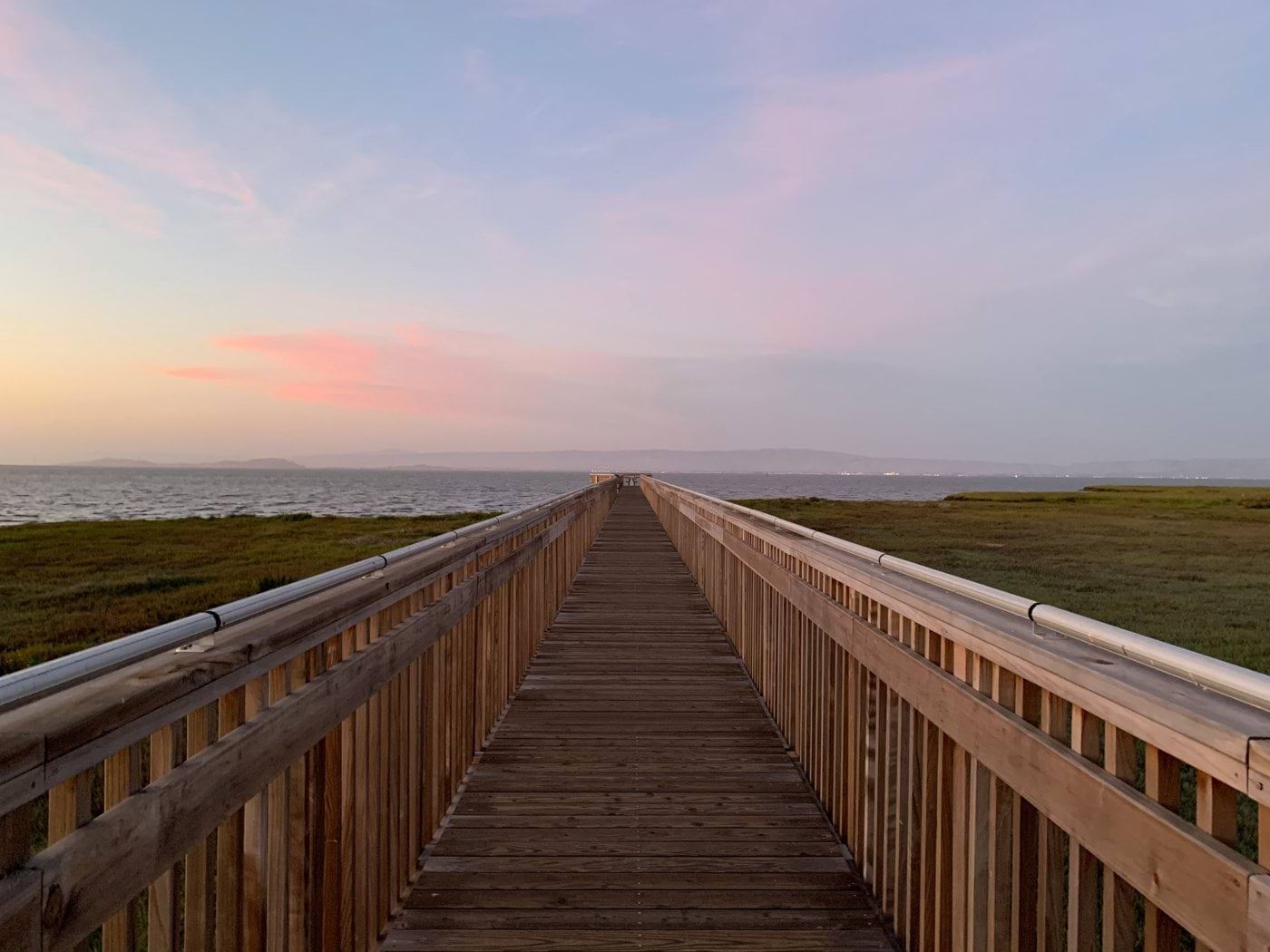 brown wooden bridge under cloudy sky during daytime