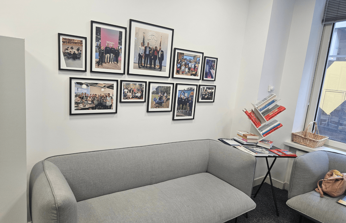 Photo showing the office sofa with a book corner and picture wall