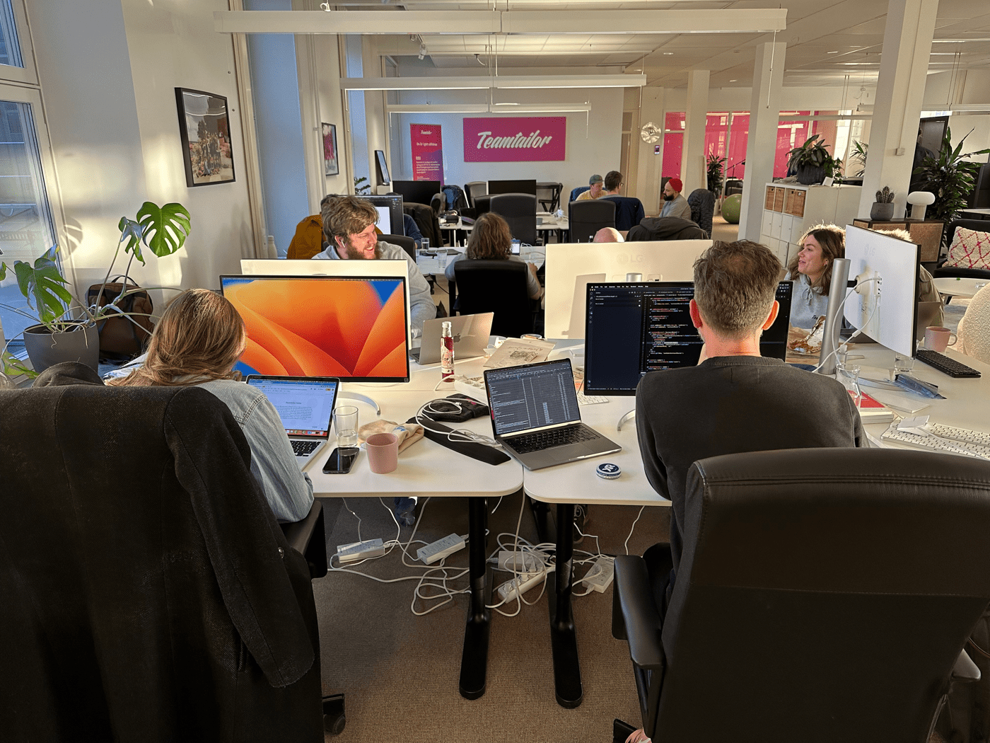 Jonas, Laura-Linnea, Suzan, and Anders working in the Stockholm office