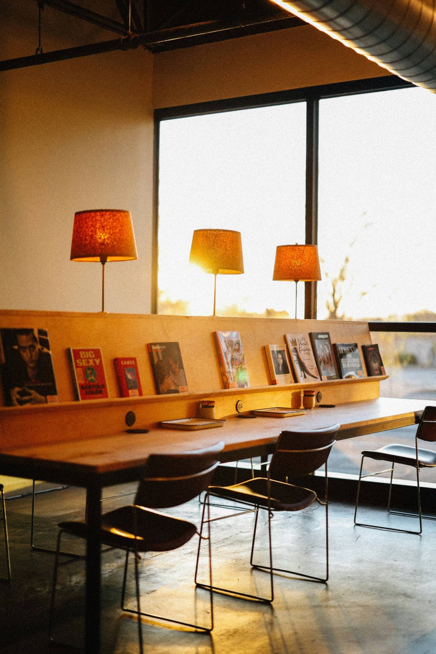 Warm lighting illuminates a modern reading space.