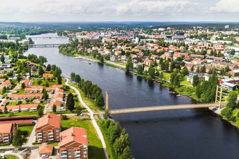 The city Skellefteå. a river with a bridge and buildings