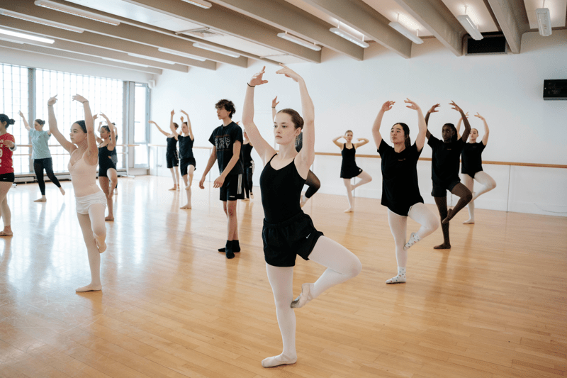 Dancers learning Ballet in a studio.