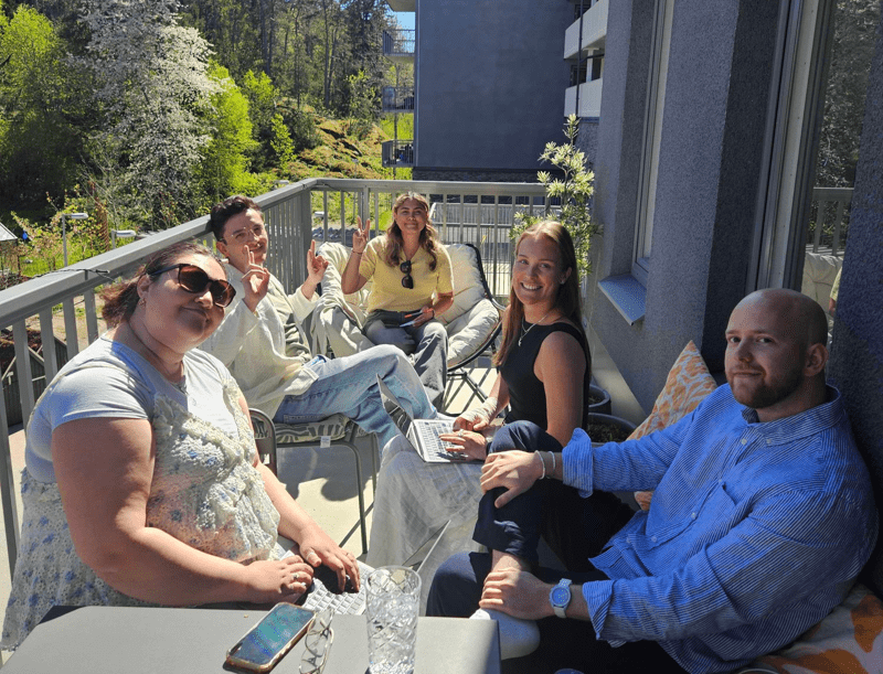A group of people sitting on a balcony