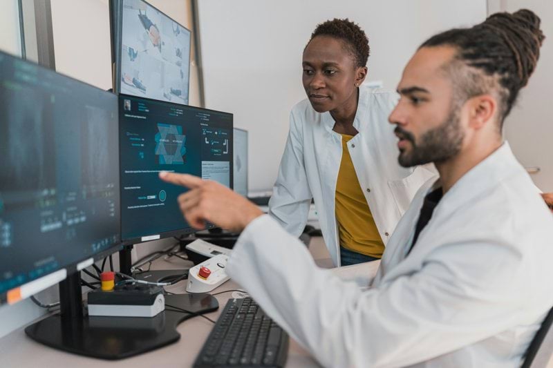 Colleagues looking at a computer screen